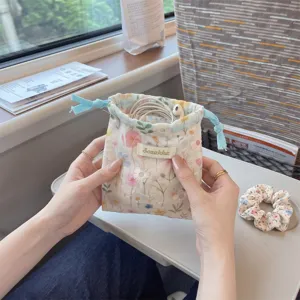 Floral drawstring storage pouch with matching scrunchie for organizing small items