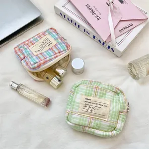 Mini quilted plaid storage bag for cosmetics and jewelry with elegant lifestyle props