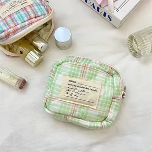 Detailed view of the macaron-colored quilted mini pouch for lipstick and jewelry storage