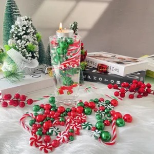 Christmas vase filler decor featuring floating pearls, candy canes and a candle for holiday setting.