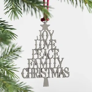 Detailed shot of a metallic Christmas tree ornament featuring stacked holiday words and red hanging cord.