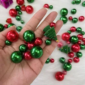 Close-up of Christmas vase filler pearls and mini resin tree decorations for holiday decor.
