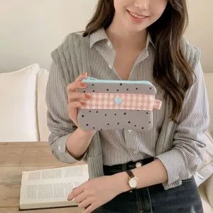 Detailed view of a stylish checkered pencil case with stars and a cute heart patch