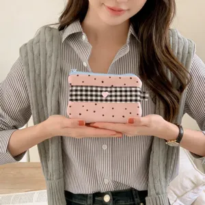 Close-up of cute pink star-patterned pencil case with checkered band and pink heart detail