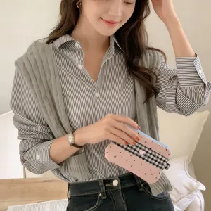 Stylish pink star and checkered pencil case held by a model in a lifestyle setting