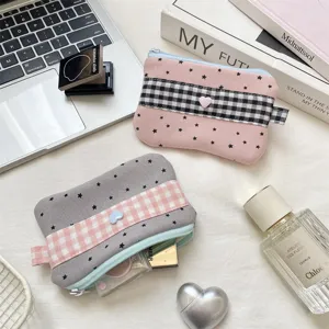 Close-up of cute checkered and star pattern fabric pencil cases with heart detail