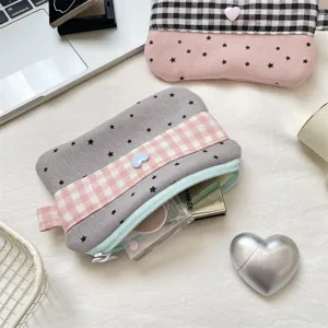 Close-up of a gray star-patterned pencil pouch with a pink gingham strap and heart button
