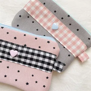 Detail showing plaid fabric and star pattern on cute pastel colored pencil cases