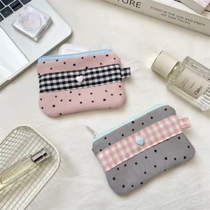 Detail view of checkered star pattern pencil cases with heart button embellishment