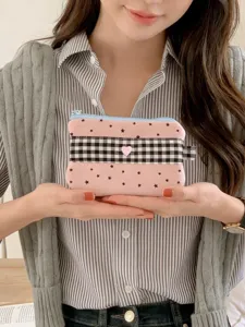 Cute pink star pattern pencil case with checkered band held by a model for stationery