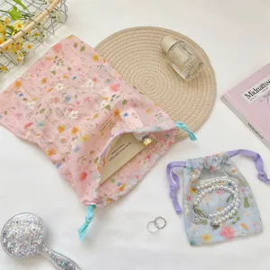 Floral drawstring cloth pouches for travel storage with elegant lifestyle props