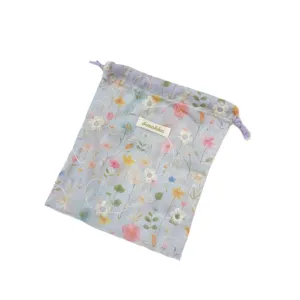 Light blue floral drawstring storage pouch with embroidery and Sozakka brand label