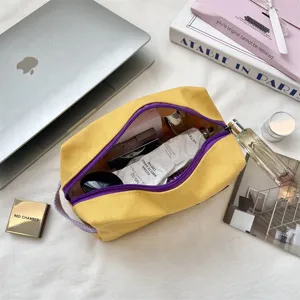 Gedetailleerd zicht op gele canvas tas gevuld met cosmetica en huidverzorging