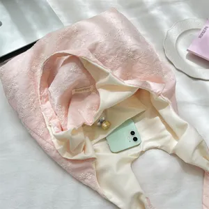 Detail view of pink cherry blossom embroidered tote bag with large capacity and inner pocket
