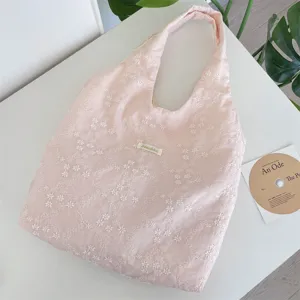 Detailed view of a pink cherry blossom embroidered tote bag with a soft gauze texture.