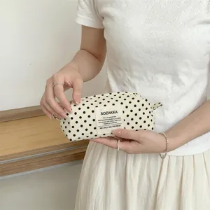 Cream canvas polka dot makeup bag, portable travel pouch for toiletries and stationery.