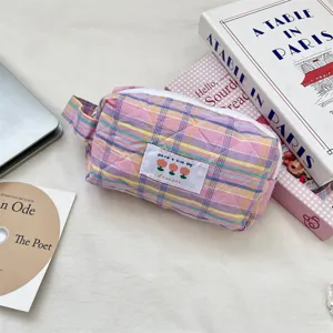 Charming pink plaid quilted makeup bag with tulip embroidery on a soft background