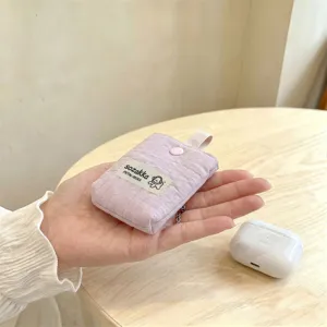 Close-up macro detail of soft lavender quilted mini storage pouch for AirPods earphone