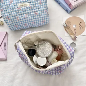 Detailed view of open purple gingham quilted cosmetic bag showing large storage capacity
