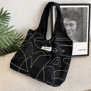 Detail der schwarzen Segeltuchtasche mit abstrakten weißen Linien und Kunst-Logo