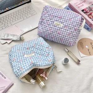 Detail of blue and purple quilted gingham makeup bags with bow patterns.