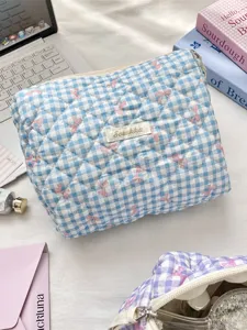 Fresh blue and white gingham quilted toiletry bag featuring a pink bow pattern design