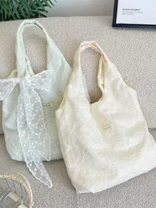 Cream floral embroidered tote bag with large lace bow for women in a soft aesthetic style