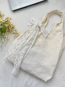 Cream cherry blossom embroidered tote bag with lace bow decoration for school or commuting.