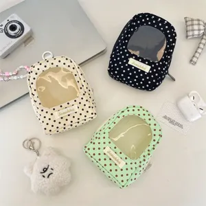 Polka-dot doll display pouches with transparent windows in cream, black, and mint colors