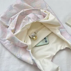 Detailed interior view of pink and blue plaid tote bag with zipper pocket and phone