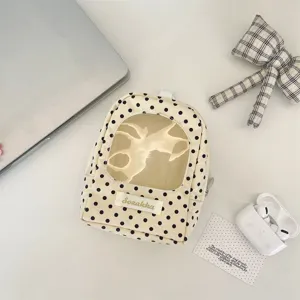 Cream white polka dot doll storage bag with transparent window and lifestyle props
