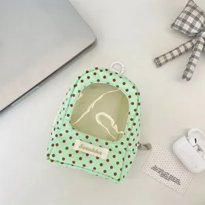 Detailed view of mint green polka dot plushie display bag with clear window