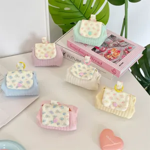 Multiple pastel quilted coin purses with floral flaps and snap button for storage