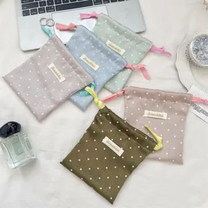 Selection of colorful polka dot satin drawstring pouches for portable jewelry storage