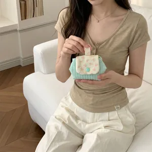 Mint green floral quilted mini storage bag for lipstick and earphones lifestyle view