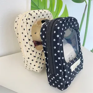 Detailed view of polka dot doll display bags featuring a large clear PVC window and zipper.
