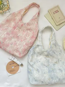 Floral embroidery tote bags in pink and blue with elegant floral branch patterns
