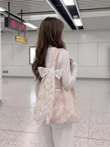 Pink embroidered floral tote bag with a large white lace bow for commuting or school.