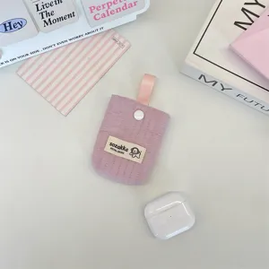 Detailed view of the quilted lilac fabric earphone pouch with a secure snap closure