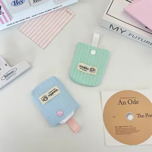 Detail showing pastel quilted earphone storage pouches for AirPods with contrast webbing