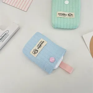 Close-up of cute quilted fabric headphone pouch with sozakka label and snap button
