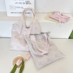 Pair of pastel pink and blue patchwork canvas tote bags in a creative studio setting