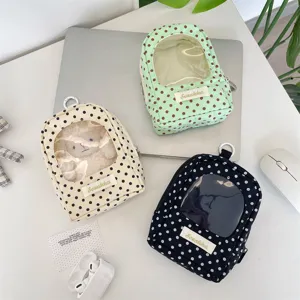 Detail view of polka dot doll display bags with transparent windows in multiple colors