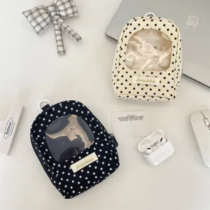 Macro view of polka dot doll storage bags featuring transparent display windows.