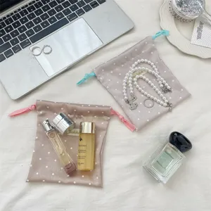 Detailed view of polka dot satin drawstring bags used for jewelry and perfume storage