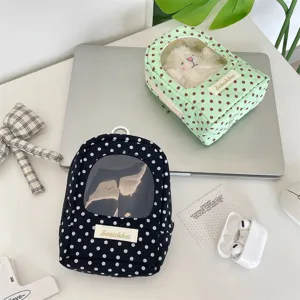 Detailed view of the polka dot doll display pouches featuring clear transparent windows