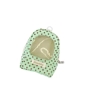 Mint green polka dot doll storage bag with transparent window and white keychain hook