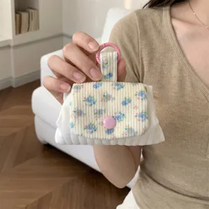 Detailed view of quilted floral coin purse with pink snap closure and clip holder