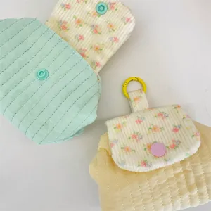 Close-up of cute quilted coin purses with floral patterns and colorful snap buttons