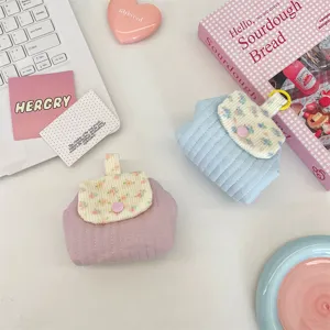 Floral quilted mini pouches for lipstick and earphone storage in soft pastel colors